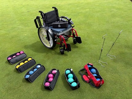 Powered wheelchair, 6 sets of junior bowls and size 0000 set of bowls, 7 bowls carriers /cases, 2 collapsible lifters